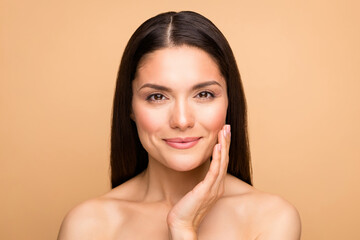 Poster - Closeup photo of naked latin lady model natural beauty without makeup touch cheek pure soft smooth skin applying anti age cream isolated beige pastel color background