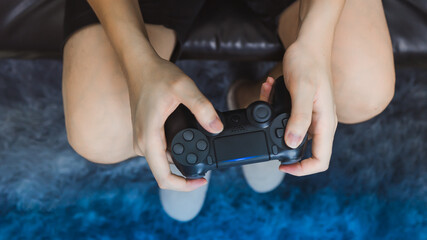 Wall Mural - Man hand holding joystick while playing the game.