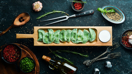 Ukrainian traditional food. Green dumplings with spinach and cheese. Top view. Rustic style.