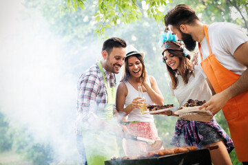 Wall Mural - Friends having fun in nature doing bbq