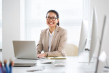 Fototapeta Londyn - Asian business woman smiling at camera in an office