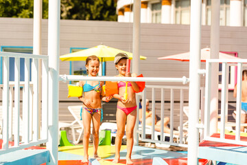 two little girls playing in the pool