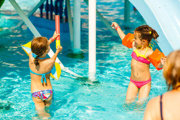 two little girls playing in the pool