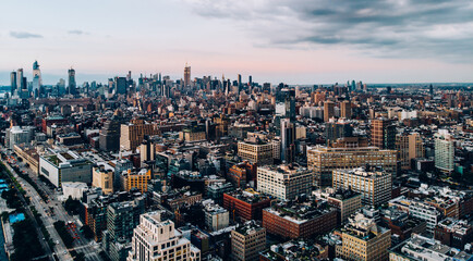 Wall Mural - Aerial view from helicopter sightseeing tour around Manhattan downtown district. Scenery bird's eye view with blocks of buildings leaving horizon. Metropolis with developed city urban infrastructure