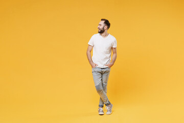 funny young bearded man guy in white casual t-shirt posing isolated on yellow background studio port