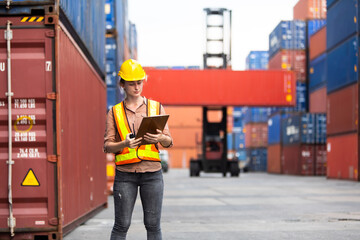 Wall Mural - Portrait of Woman foreman worker use walkie talkie for control loading Containers box from Cargo at container yard. Import and Export concept. Marine, carrier and logistic insurance .