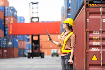 Wall Mural - Portrait of Woman foreman worker use walkie talkie for control loading Containers box from Cargo at container yard. Import and Export concept. Marine, carrier and logistic insurance .