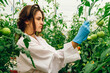 © Tasty Content  - Girl scientist farmers check the growth of plants on an organic farm. Check in the tablet.