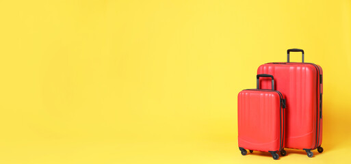 Stylish suitcases on yellow background, space for text. Banner design