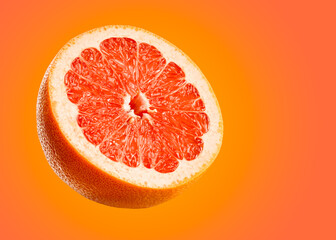 Wall Mural - Grapefruit closeup isolated on orange background. Very detailed macro shoot with subject on left and copy space on right.