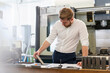© Westend61 - Man looking at plan and workpiece in a factory