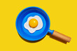 © Westend61 - Illustration of fried egg on blue pan against yellow background