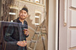 © Westend61 - Man refurbishing shop location, drinking coffee, looking out of window