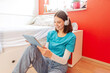© Westend61 - Portrait of smiling teenage girl with headphones and digital tablet learning at home
