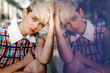 © Westend61 - Portrait of female teenager wearing colorful dress mirrored in glass pane