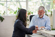 © Bec Hannaford/Austockphoto - Mature aged male office worker meeting with a woman in a creative warehouse space