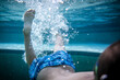 © Brayden Howie/Austockphoto - Kids swim and kick under water in their backyard pool