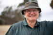 © Caro Telfer/Austockphoto - smiling old man wearing glasses and grubby bucket hat