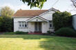 © DAVID VEENTJER/Austockphoto - A small, white, old weatherboard house