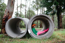 Young Girl, Sitting In Drainage Pipes