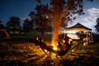 © Lachlan Gardiner/Austockphoto - Family sitting around campfire
