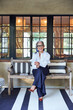 © Trinette Reed/Stocksy - Portrait of beautiful and stylish mature woman interior designer with grey hair sitting on front porch