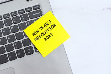 Wall Mural - New Year's Resolutions 2021 text on sticky note on top laptop