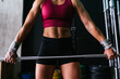 © Kike Arnaiz/Stocksy - Close up of muscular young fitness woman lifting a weight