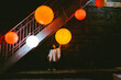 © JImena Roquero/Stocksy - Scene of a kid under the stairs touching a big orange lamp