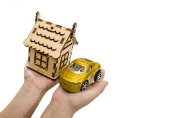 toy car and wooden house in the hands of a man on a white background. Business concept. Real estate concept. An alternative to buying a home and a car.Copy of space.