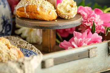 Wall Mural - Breakfast with croissants, leaves, flowers composition with retro plates on wooden background