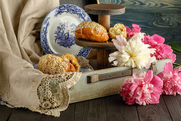 Wall Mural - Breakfast with croissants, leaves, flowers composition with retro plates on wooden background