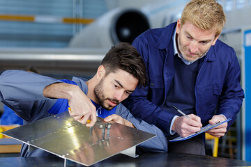 portrait of two metal factory workers