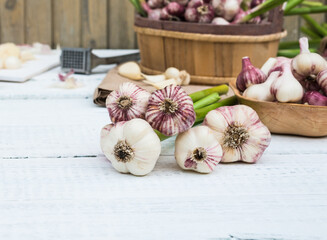 Raw Vegetables Fresh Harvest. Garlic Cloves and Garlic Bulb on a white wooden rustic table
