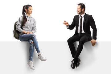 female student and a businessman sitting on a panel and talking