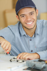 a smiling machinist with spanner