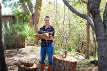 Woman Chopping Wood Outdoors