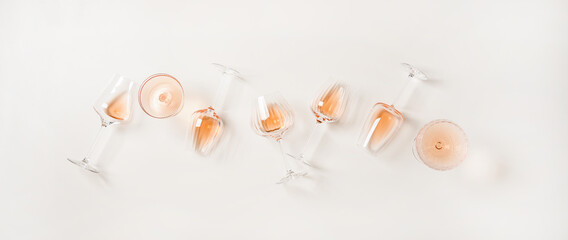 Rose wine variety layout. Flat-lay of rose wine in various glasses over plain white background, top view. Summer drink for party, wine shop or wine tasting concept