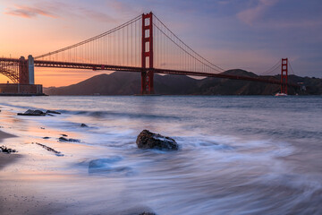 Wall Mural - Sunset at the beach by the Golden Gate Bridge in San Francisco California