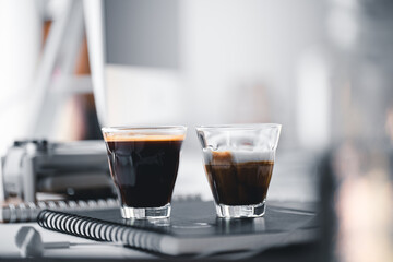 Hot coffee in a cup at the computer desk