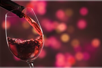 Wall Mural - Red wine and glass on bokeh background