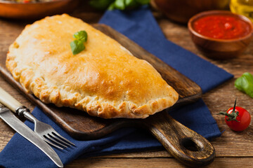 Wall Mural - Italian calzone with mushrooms and ham.