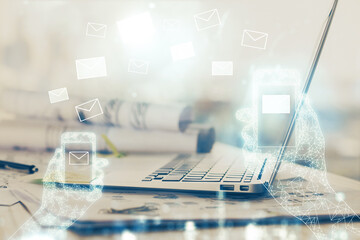 Desktop computer background in office and flying envelops hologram drawing. Multi exposure. Electronic mail concept.