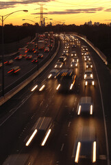 Blurred lights of traffic leaving Melbourne at Sunset on the freeway to the east.