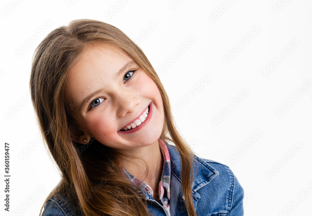 Portrait of adorable smiling little girl child preteen sitting isolated