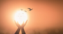 World Mental Health Day Concept: Silhouette Prayer Praise God And Bird Flying On Blurred Candle Light Background