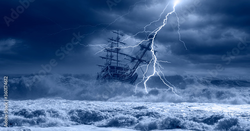 Fotografía Sailing old ship in storm sea on the background heavy clouds with lightning