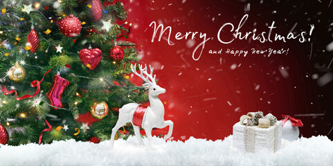 Beautiful green decorated Christmas tree and white Christmas deer with gifts on evening dark red background with flying snow fluffs and inscription Merry Christmas. Bright colorful artistic image.