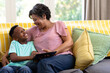 © WavebreakMediaMicro - Mixed race boy and his grandmother enjoying their time at home together
