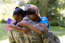 African American Man Wearing A Military Uniform Holding His Children